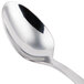 A close-up of a Libbey stainless steel demitasse spoon with a white handle.