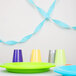 A Bermuda Blue streamer on a table with colorful plates and cups.