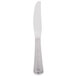 A silver Libbey Fairfield dinner knife with a white handle.