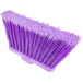 A close-up of a Carlisle purple broom head with long bristles.