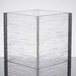 A clear square acrylic riser with a textured surface.