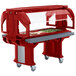 A red Cambro Versa food/salad bar on heavy-duty casters with a tray of food.