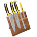 A group of Mercer Culinary Millennia® knives on a wooden block.