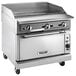 A Vulcan stainless steel liquid propane range with griddle top on wheels.
