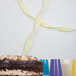 A chocolate cake with a yellow ribbon on a white surface.
