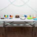 A table with a Fresh Mint Green streamer on it, with plates and cups and a cake.