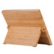 A Mercer Culinary bamboo board with brown handles on a wooden stand.
