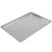 A Vollrath aluminum bun/sheet pan with a wire in rim on a counter.