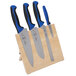 A Mercer Culinary Millennia Colors 5-piece knife set with blue handles on a wooden stand.