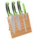 A Mercer Culinary Millennia Colors® 5-piece knife set with green handles on a bamboo magnetic board.