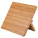 A Mercer Culinary Millennia® bamboo magnetic board with a black handle on a wooden base.