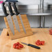 A Mercer Culinary Millennia® knife set on a bamboo magnetic board.
