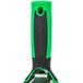 An Unger ErgoTec window squeegee with a green and black handle.