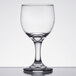 An Anchor Hocking clear wine glass on a white surface.