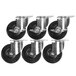 A group of black and chrome caster wheels for a Cooking Performance Group range.