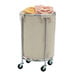 A Chrome laundry cart with a beige laundry bag in it.
