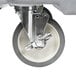 A close-up of a wheel on a metal base with Cambro KSC402191 Granite Gray CamKiosk Portable Self-Contained Hand Sink Cart.