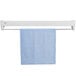 A white towel hanging on a 40 5/8" white wall mount drying rack.