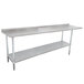 A long stainless steel Advance Tabco work table with a shelf.