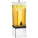 A Cal-Mil clear plastic beverage dispenser with yellow liquid and lemons inside.