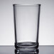 A clear Libbey tumbler with a black rim on a table.