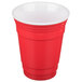 A red plastic tumbler with a white rim.