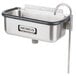 A stainless steel Nemco ice cream dipper well with a metal faucet on a counter.