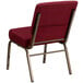 A burgundy Flash Furniture church chair with gold legs.