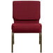 A burgundy Flash Furniture church chair with gold metal legs.