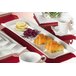 A CAC Times Square rectangular white china platter with food on a table.