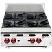 A stainless steel Wolf countertop range with four burners.