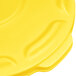A yellow plastic lid with a curved handle.