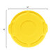 A yellow plastic Rubbermaid lid for a 10 gallon trash can with a handle and a circle in the middle.