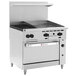 A large stainless steel Wolf commercial range with two burners, a griddle, and a standard oven.