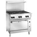 A large stainless steel Wolf commercial gas range with six burners and a standard oven.