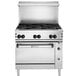 A Wolf by Vulcan stainless steel commercial gas range with 6 burners and a standard oven with black knobs.