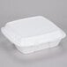 A Dart white foam square take out container with a square vented lid.