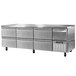 A large stainless steel undercounter refrigerator with 6 drawers and 1 half door.