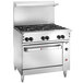 A large stainless steel Wolf commercial range with six burners and an oven.