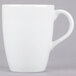 A close-up of a 10 Strawberry Street Classic White porcelain barrel mug with a handle.