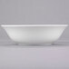 A 10 Strawberry Street Classic White porcelain cereal bowl on a gray surface.