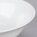 A close up of a 10 Strawberry Street white porcelain cereal bowl with a white rim.