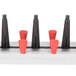 A black and red plastic Plate Mate wall mount rack holding 12 plates.