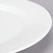 A close-up of a 10 Strawberry Street Classic White porcelain lunch plate with a rim.