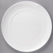 A white porcelain dinner plate with a white rim.