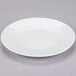 A 10 Strawberry Street Classic White porcelain salad/dessert plate with a rim on a gray surface.