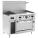 A large stainless steel Wolf commercial range with 2 burners, a griddle, and an oven.