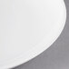 A close-up of a 10 Strawberry Street white porcelain saucer.