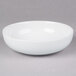 A 10 Strawberry Street classic white porcelain pasta bowl on a gray surface.