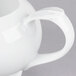 A close-up of a white jug with a handle.